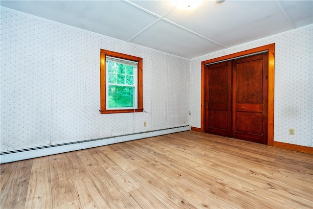 3442 Flat River Rd, Coventry, RI 02816 - unfurnished bedroom with a baseboard heating unit, wood finished floors, crown molding, and a closet