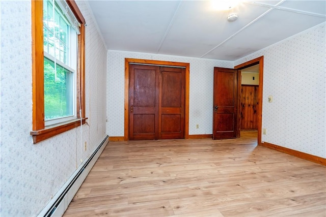 3442 Flat River Rd, Coventry, RI 02816 - unfurnished bedroom with a baseboard heating unit and light wood-style floors