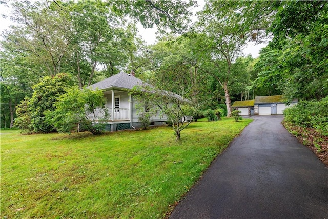 3442 Flat River Rd, Coventry, RI 02816 - view of front of property featuring a detached garage, a front yard, a chimney, and a porch