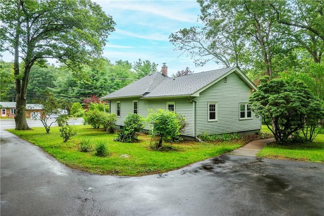 3442 Flat River Rd, Coventry, RI 02816 - view of side of home with a chimney, roof with shingles, and a lawn
