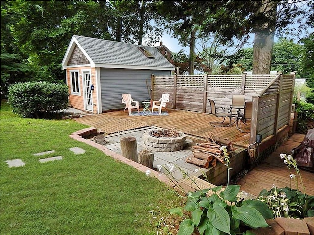 46 Highland Ave, Westerly, RI 02891 - deck featuring a fire pit, an outbuilding, and a lawn