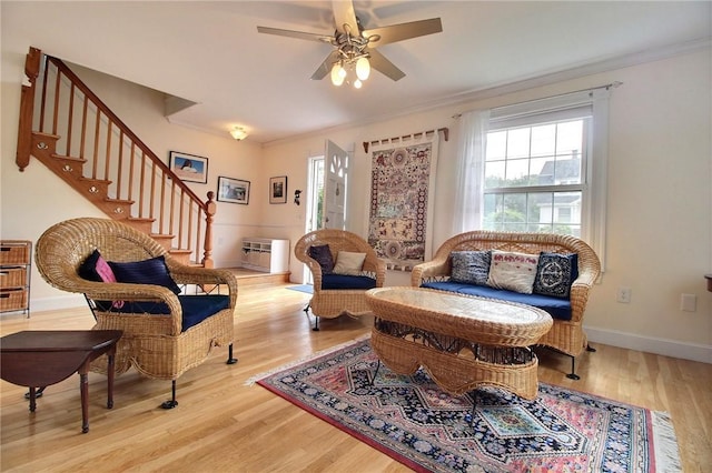 46 Highland Ave, Westerly, RI 02891 - living area featuring crown molding, wood finished floors, stairs, and ceiling fan