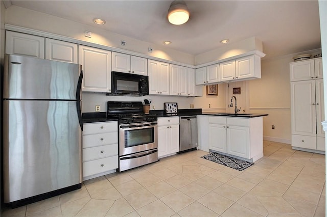 46 Highland Ave, Westerly, RI 02891 - kitchen with appliances with stainless steel finishes, dark countertops, a peninsula, light tile patterned floors, and recessed lighting