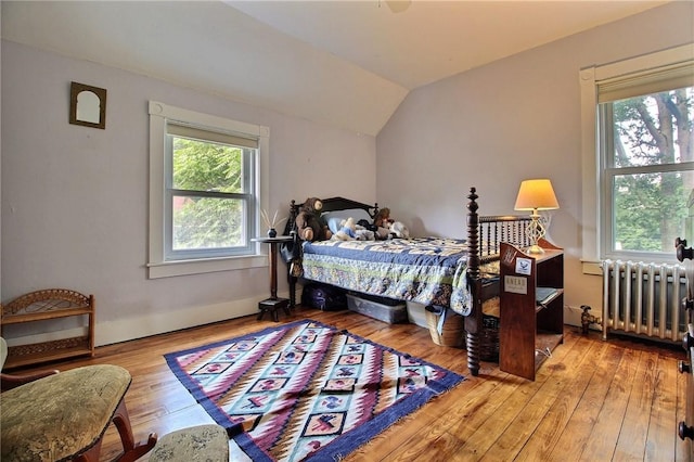 46 Highland Ave, Westerly, RI 02891 - bedroom with radiator, multiple windows, wood-type flooring, and vaulted ceiling