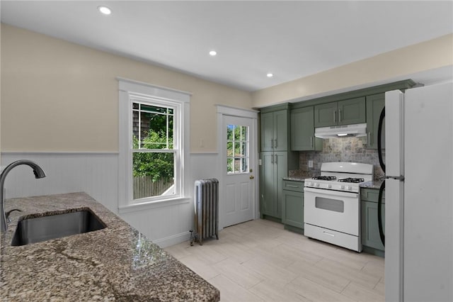 8 Parkman St, Providence, RI 02907 - kitchen featuring green cabinets, radiator, under cabinet range hood, white appliances, and dark stone counters