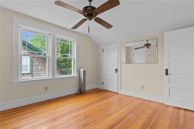 8 Parkman St, Providence, RI 02907 - spare room featuring radiator heating unit, light wood finished floors, a ceiling fan, and lofted ceiling