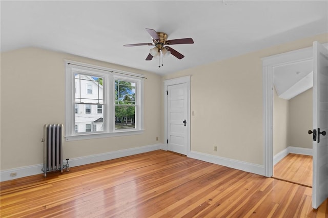 8 Parkman St, Providence, RI 02907 - unfurnished living room featuring radiator heating unit, light wood-style floors, a ceiling fan, and lofted ceiling