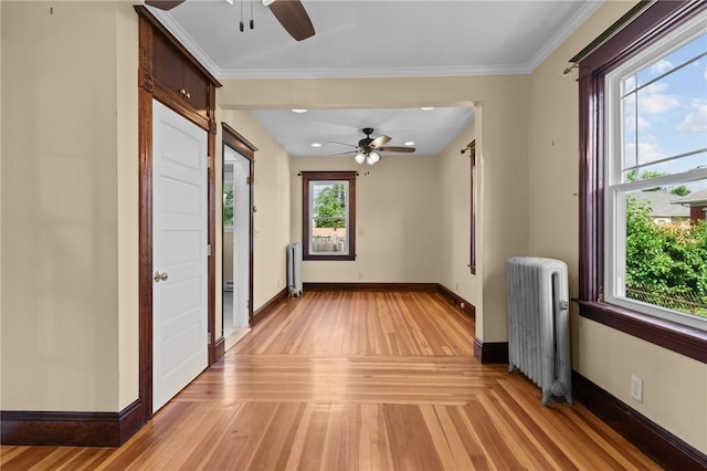 8 Parkman St, Providence, RI 02907 - unfurnished room featuring radiator heating unit, ceiling fan, light wood-style flooring, and crown molding