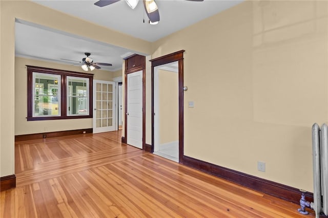 8 Parkman St, Providence, RI 02907 - empty room featuring a ceiling fan, light wood finished floors, and radiator heating unit