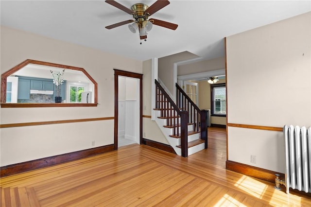 8 Parkman St, Providence, RI 02907 - spare room with radiator, a ceiling fan, light wood-style flooring, and stairway