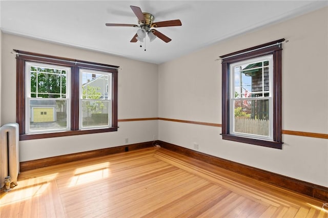 8 Parkman St, Providence, RI 02907 - spare room with radiator heating unit, a ceiling fan, and wood finished floors