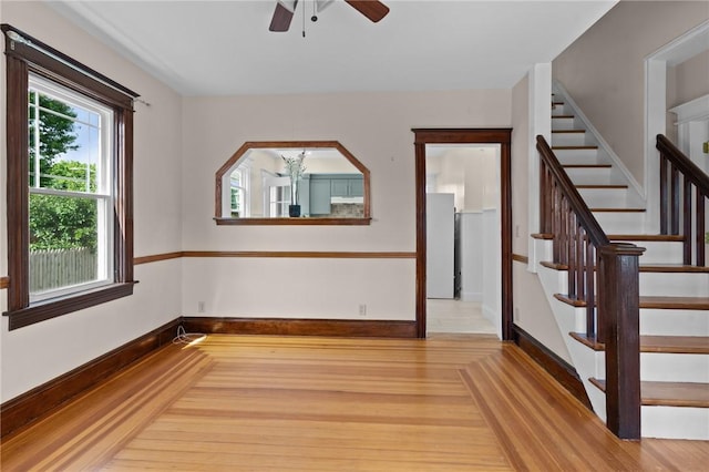 8 Parkman St, Providence, RI 02907 - empty room with stairs, a ceiling fan, and wood finished floors