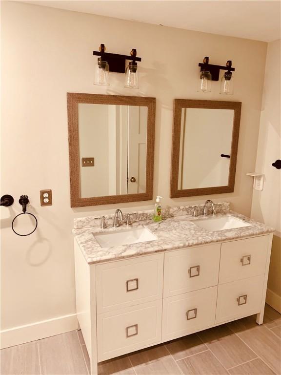 724 Centerville Rd Unit 6, Warwick, RI 02886 - full bathroom featuring double vanity and baseboards