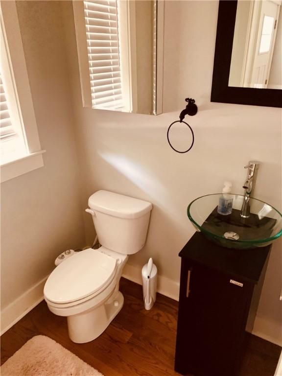 724 Centerville Rd Unit 6, Warwick, RI 02886 - half bathroom featuring vanity and wood finished floors