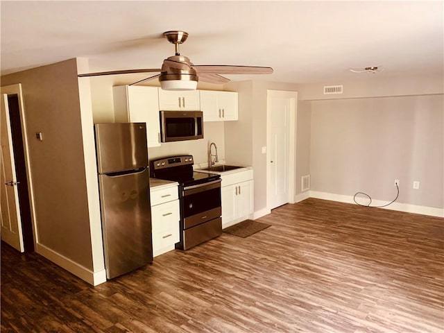 724 Centerville Rd Unit 6, Warwick, RI 02886 - kitchen featuring stainless steel appliances, dark wood finished floors, white cabinets, a ceiling fan, and light countertops