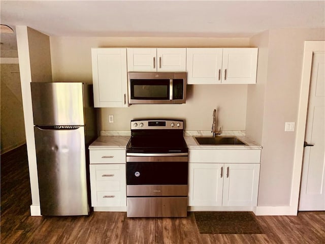724 Centerville Rd Unit 6, Warwick, RI 02886 - kitchen featuring stainless steel appliances, dark wood-type flooring, white cabinets, and light countertops