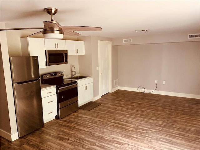 724 Centerville Rd Unit 6, Warwick, RI 02886 - kitchen with stainless steel appliances, dark wood-style floors, ceiling fan, white cabinets, and light countertops