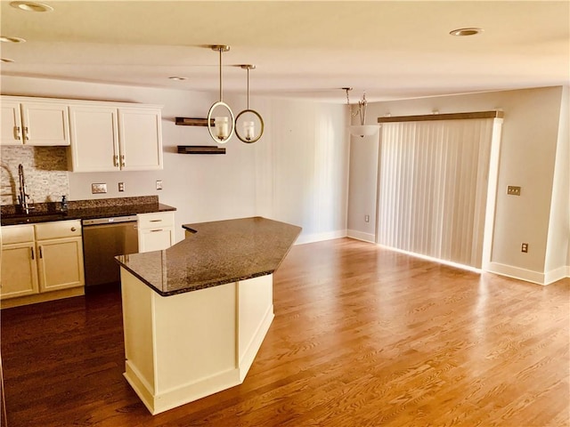 724 Centerville Rd Unit 6, Warwick, RI 02886 - kitchen with dishwasher, dark wood finished floors, backsplash, dark stone countertops, and pendant lighting