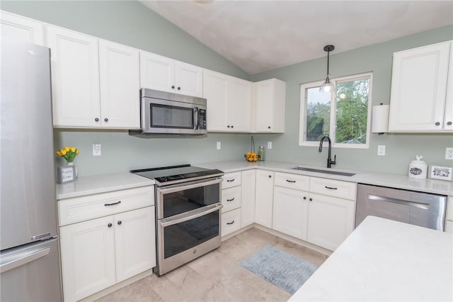 36 Wadsworth St, Warwick, RI 02889 - kitchen featuring appliances with stainless steel finishes, lofted ceiling, white cabinets, and light countertops