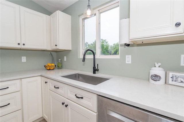 36 Wadsworth St, Warwick, RI 02889 - kitchen with dishwasher, white cabinetry, light countertops, and hanging light fixtures