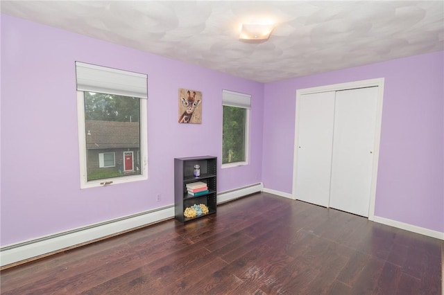 36 Wadsworth St, Warwick, RI 02889 - unfurnished bedroom with a baseboard heating unit, wood finished floors, and a closet