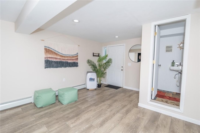 36 Wadsworth St, Warwick, RI 02889 - foyer entrance featuring wood finished floors, a baseboard radiator, and recessed lighting