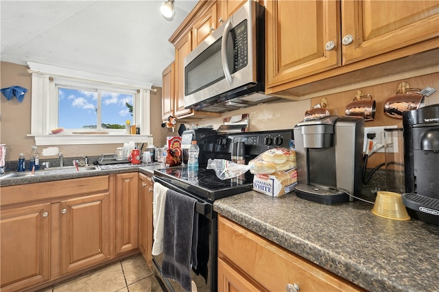 79 Winthrop St, Woonsocket, RI 02895 - kitchen with electric range, stainless steel microwave, dark countertops, and light tile patterned flooring