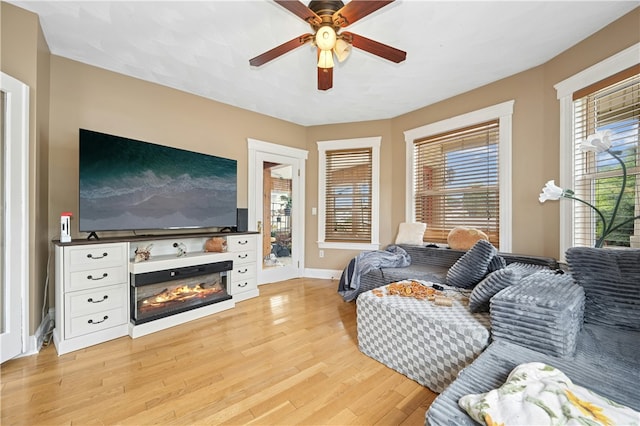79 Winthrop St, Woonsocket, RI 02895 - living area featuring a ceiling fan, light wood-style floors, and a glass covered fireplace