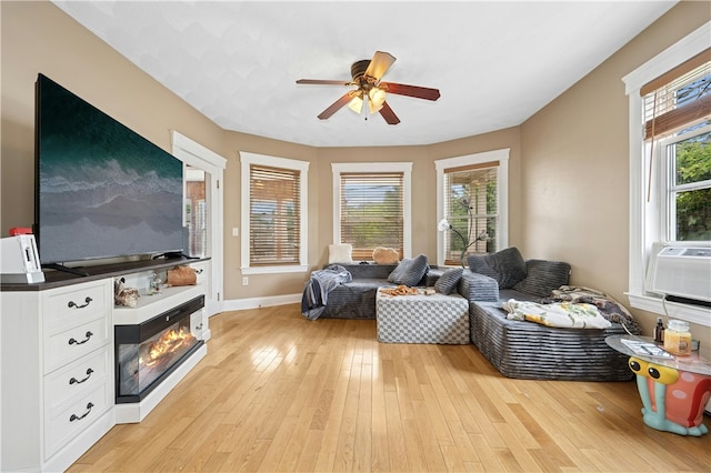 79 Winthrop St, Woonsocket, RI 02895 - living room with ceiling fan, a glass covered fireplace, and light wood-style flooring