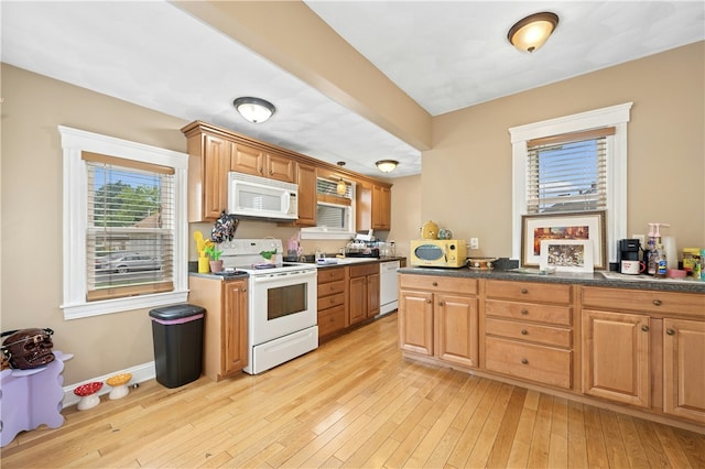 79 Winthrop St, Woonsocket, RI 02895 - kitchen featuring white appliances, light wood finished floors, and dark countertops
