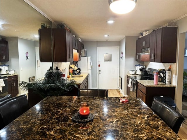 300 Smithfield Rd Unit B2-7, North Providence, RI 02904 - kitchen with range with electric stovetop, ornamental molding, freestanding refrigerator, dark brown cabinets, and under cabinet range hood