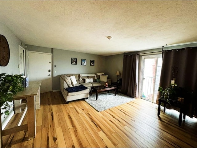 300 Smithfield Rd Unit B2-7, North Providence, RI 02904 - living area featuring a textured ceiling and light wood finished floors