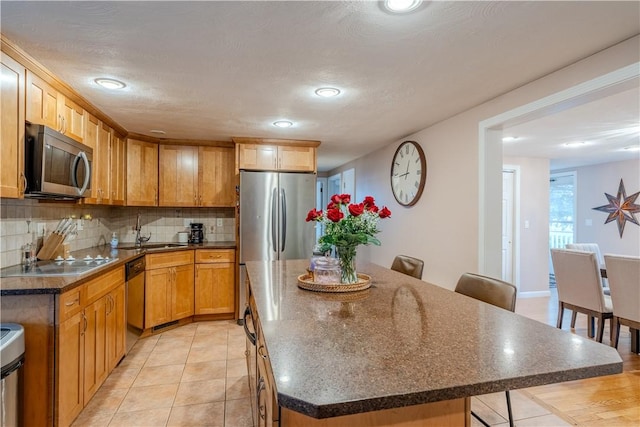 6 Jacksonia Dr, North Providence, RI 02911 - kitchen featuring stainless steel appliances, a kitchen island, backsplash, recessed lighting, and a kitchen bar
