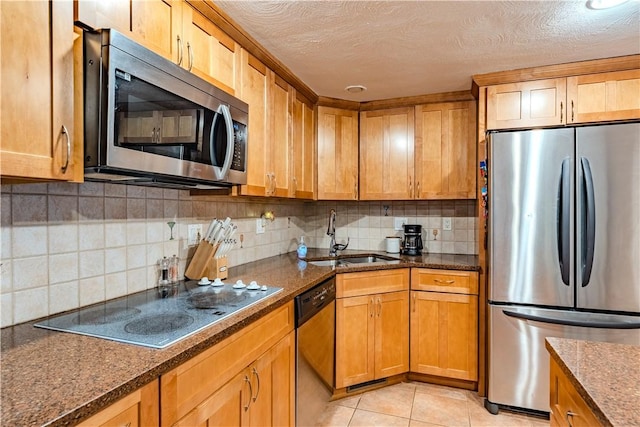 6 Jacksonia Dr, North Providence, RI 02911 - kitchen with appliances with stainless steel finishes, backsplash, dark stone counters, light tile patterned floors, and a textured ceiling