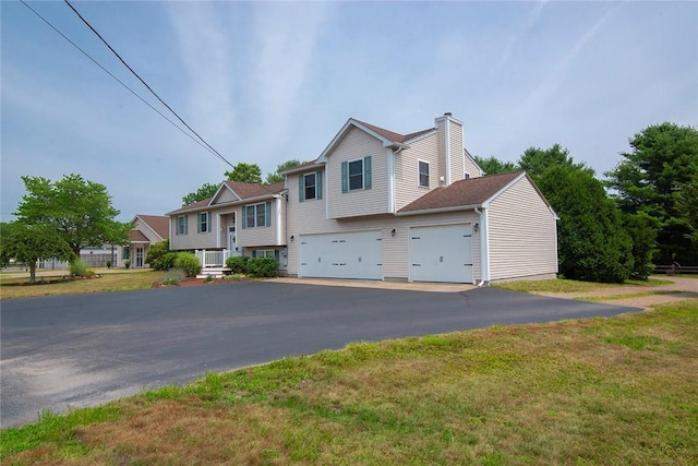 350 Narrow Ln, Charlestown, RI 02813 - view of front of house with a chimney, driveway, a garage, and a front lawn