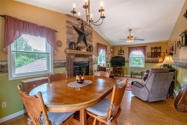 350 Narrow Ln, Charlestown, RI 02813 - dining area with lofted ceiling, a fireplace, wood finished floors, a chandelier, and a ceiling fan