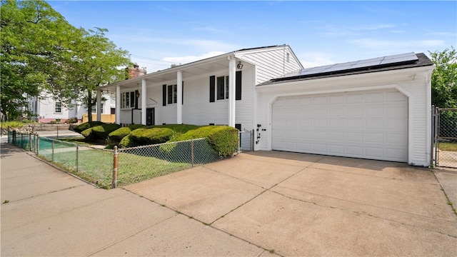 50 Tobey St, Providence, RI 02909 - view of front of property featuring a chimney, solar panels, driveway, and a garage