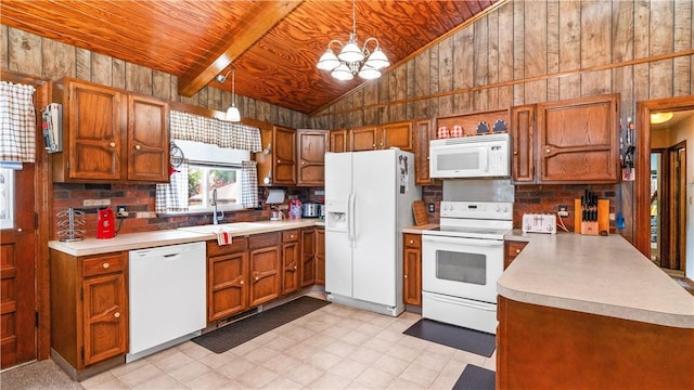 50 Tobey St, Providence, RI 02909 - kitchen featuring white appliances, lofted ceiling, wooden walls, a chandelier, and light countertops