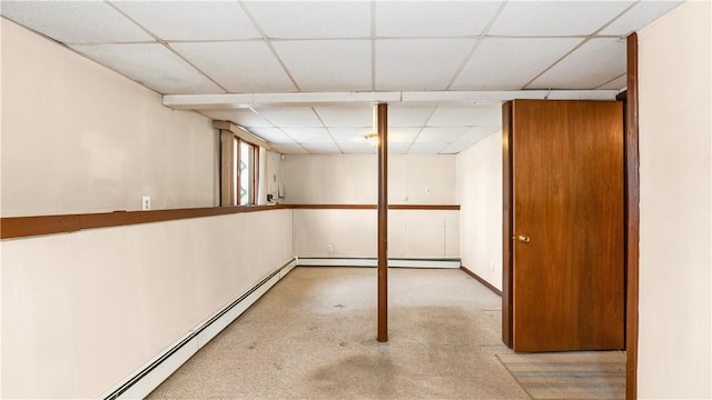 50 Tobey St, Providence, RI 02909 - below grade area with a paneled ceiling, a baseboard heating unit, and carpet floors