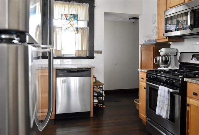 443 Harrington Ave, Warwick, RI 02888 - kitchen featuring appliances with stainless steel finishes, backsplash, dark wood-style flooring, and light stone countertops