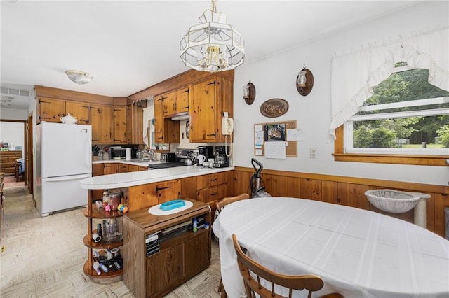 226 Westcott Rd, Scituate, RI 02857 - kitchen featuring freestanding refrigerator, brown cabinets, light countertops, a peninsula, and stainless steel microwave