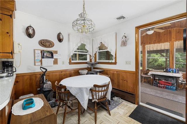 226 Westcott Rd, Scituate, RI 02857 - dining area with a baseboard heating unit, wood walls, wainscoting, and a chandelier