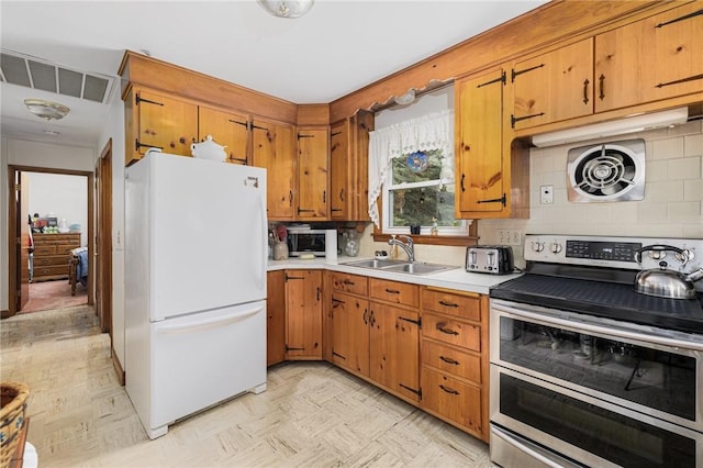 226 Westcott Rd, Scituate, RI 02857 - kitchen featuring appliances with stainless steel finishes, light countertops, tasteful backsplash, and brown cabinets