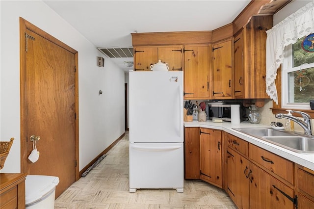 226 Westcott Rd, Scituate, RI 02857 - kitchen featuring freestanding refrigerator, light countertops, brown cabinets, and stainless steel microwave