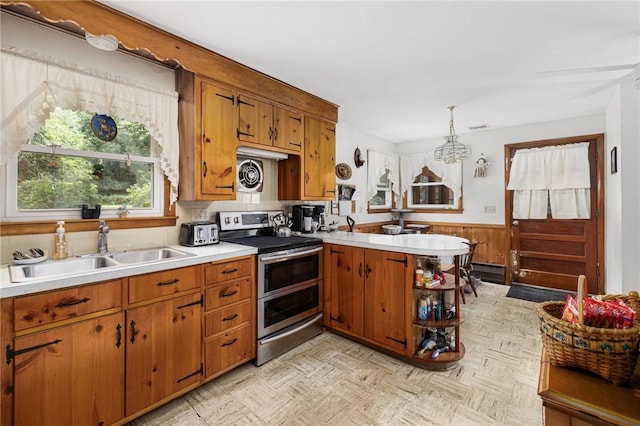226 Westcott Rd, Scituate, RI 02857 - kitchen with double oven range, brown cabinets, wainscoting, light countertops, and wooden walls