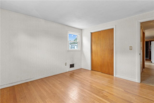 352 Cove Ave, Warwick, RI 02886 - unfurnished bedroom featuring light wood-type flooring, a closet, and freestanding refrigerator