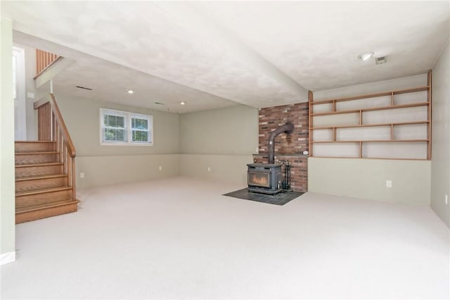 5 Spirketing St, Jamestown, RI 02835 - unfurnished living room featuring a wood stove, stairway, and carpet floors