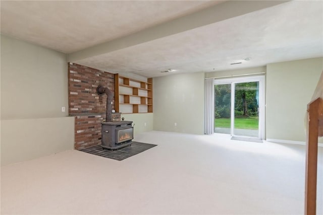 5 Spirketing St, Jamestown, RI 02835 - unfurnished living room with carpet flooring and a wood stove