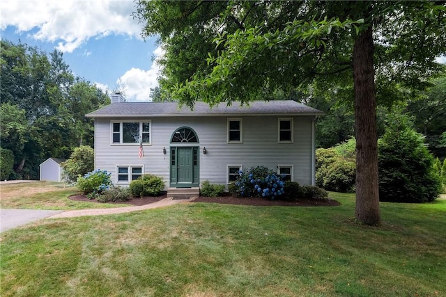 5 Spirketing St, Jamestown, RI 02835 - split foyer home featuring a chimney, a front yard, and a storage shed