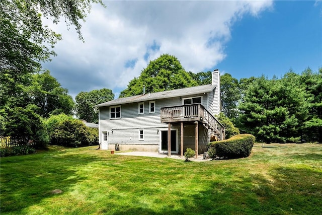 5 Spirketing St, Jamestown, RI 02835 - rear view of house featuring a chimney, a wooden deck, a yard, a patio, and stairs